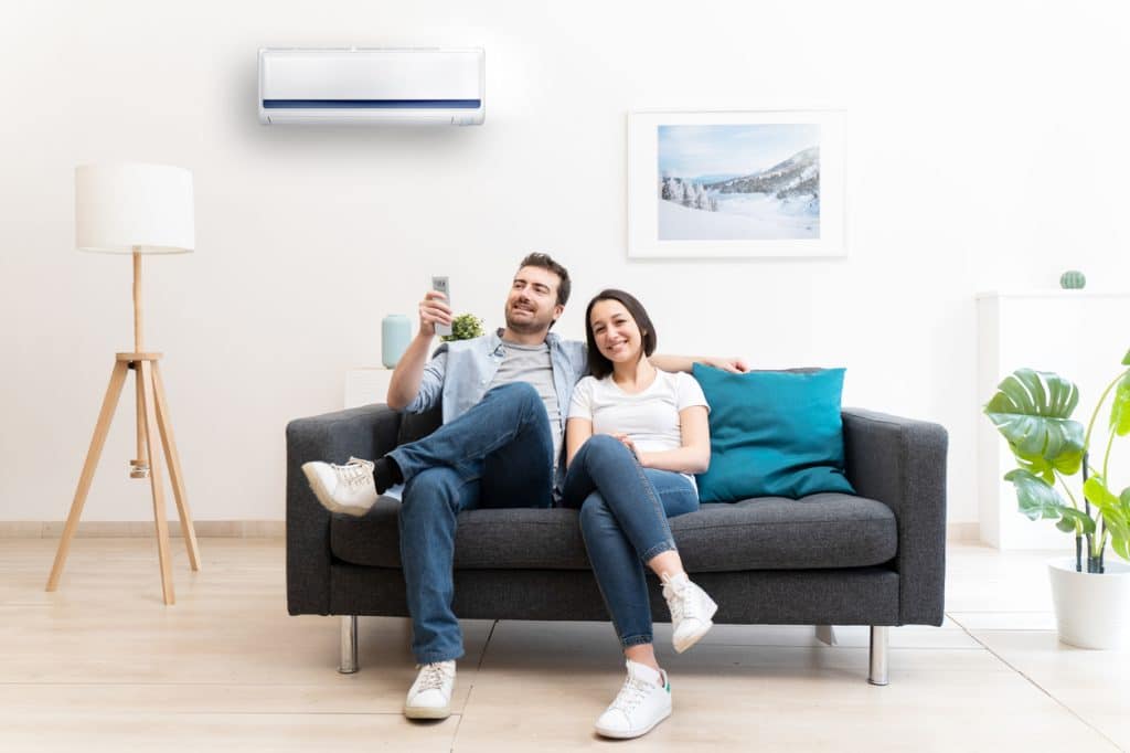 couple using air conditioner at home